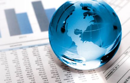 Glass globe on financial papers