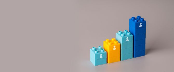 Stacked legos at different heights with people icons