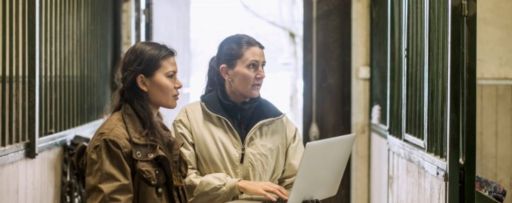 two women working on a laptop