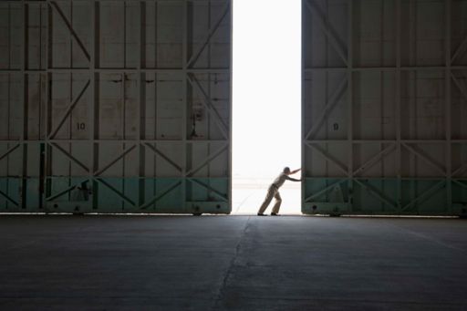 Person opening a hangar door