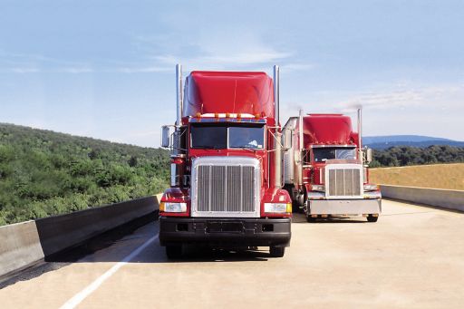 KPMG IFRS Leases topic image: Two red trucks on a highway