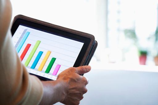 businesswoman looking at bar graph on digital tablet