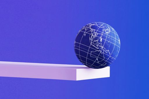 World globe balanced on the edge of a shelf