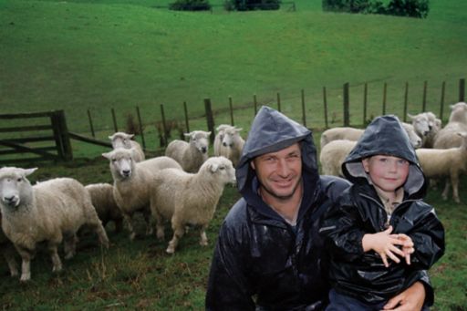 Farmer and boy with sheep in background