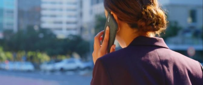 Back view of a businesswomen wearing formals talking phone