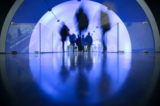 blurred-people-walking-blue-lighted-arc