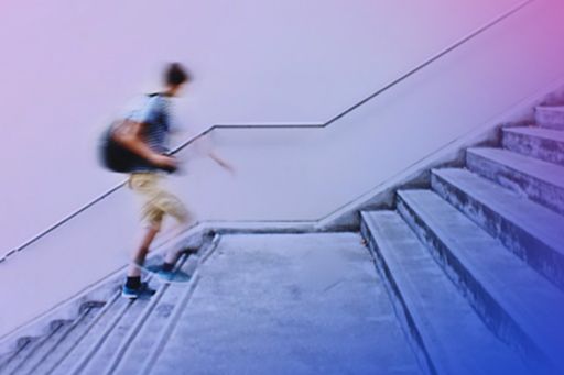 Blurred student walking up stairs