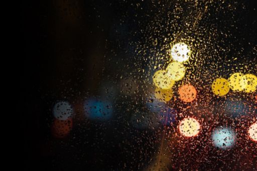 Bokeh effect photography of lights through water drops on window