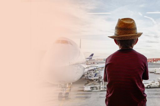 Boy wearing hat looking at airplane