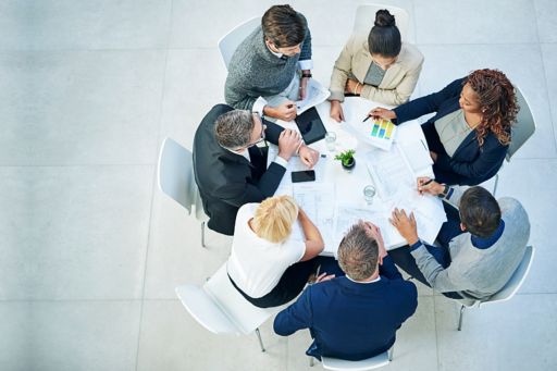 Group of business people meeting around a white table