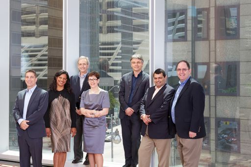Business people standing infront of glass building