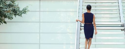 Businesswoman going up stairs in office