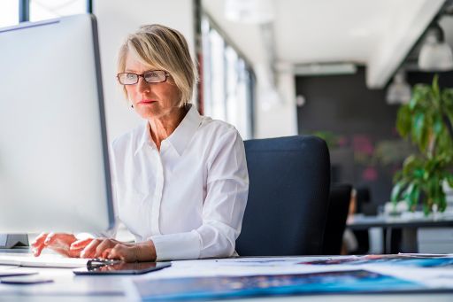 Businesswoman using computer at desk in office