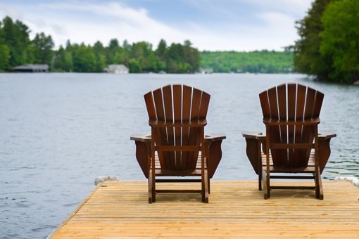Deck chairs on dock by lake