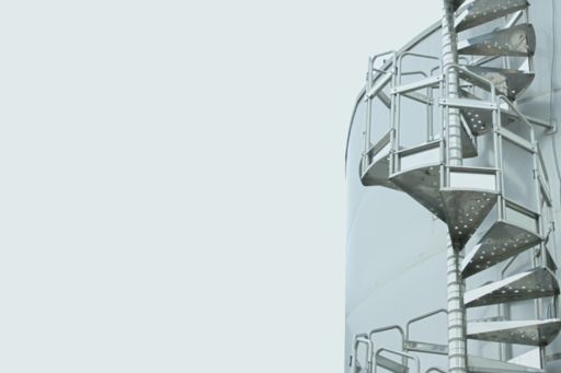 Front-view of circular steel stairs against white background