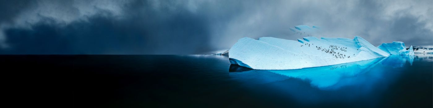Climate change iceberg with penguins in ocean