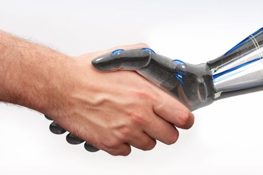 Closeup of human and robot shaking hands