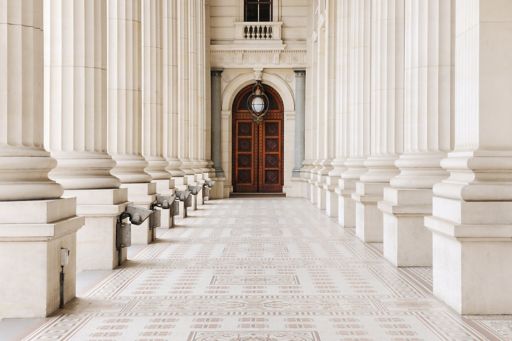 Marble columns and wooden door entrance to beautiful building
