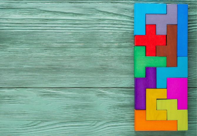 Colorful tetris blocks joint wooden background