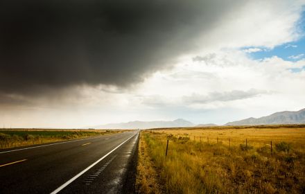 Dark clouds over an empty road