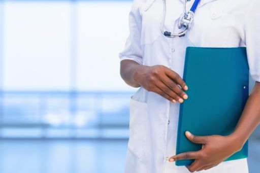 Doctor holding blue green file wearing stethoscope white coat