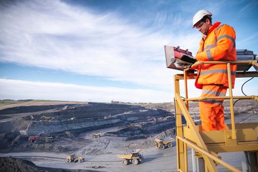 Ecologist with digital tablet surveys a coal mine