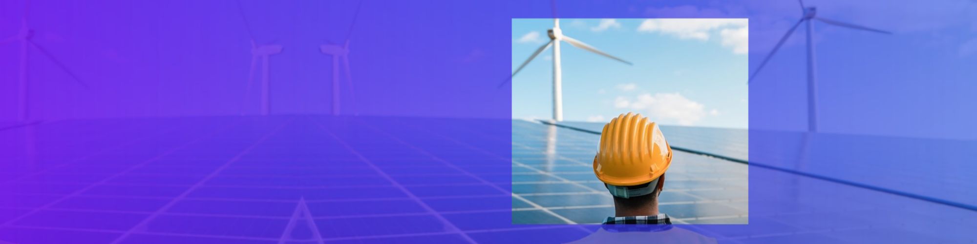 engineer looking at solar panels and wind turbines