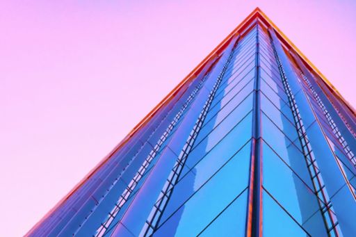 Glass building against a pink sky