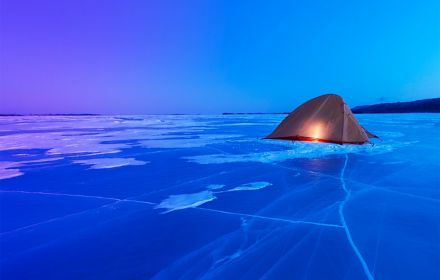 Glowing tent in snowy area