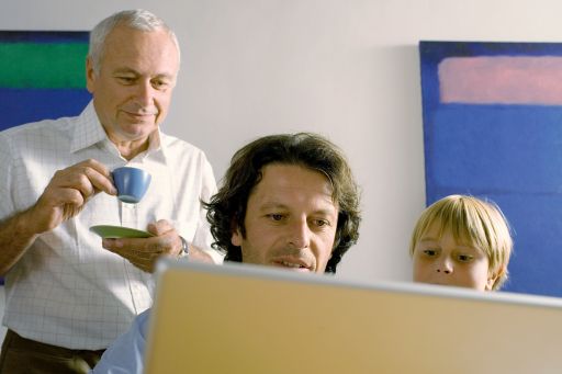 Grandson and grandfather looking at laptop