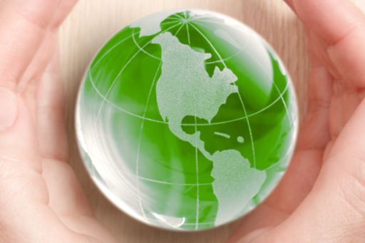 Green glass globe in hand