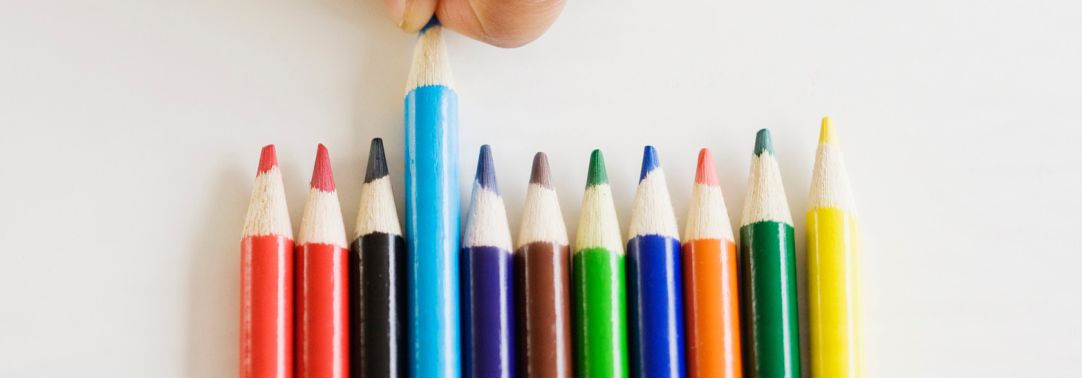 Hand grabbing colorful pencil