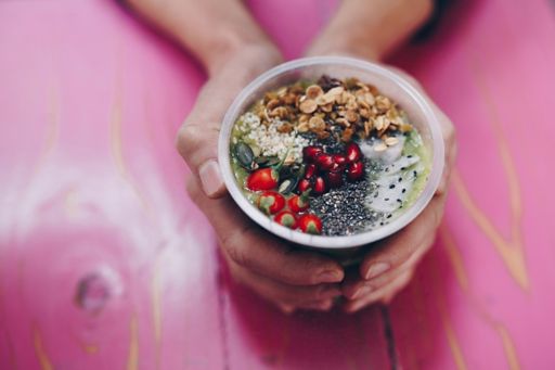 Hands holding smoothie bowl