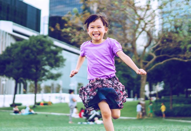 Happy girl running in local park
