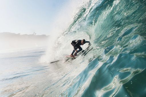 Surfer surfing inside barrel of wave