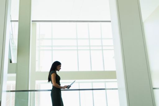 Hispanic businesswoman using digital tablet in office