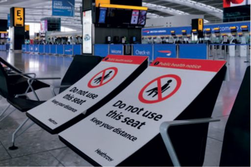 Seats in airport with sign "do not use this seat"