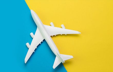 Toy plane on blue and yellow background