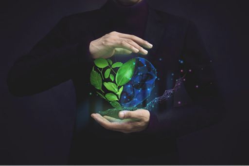 Heart made of leaves and a blue neon mesh held between hands, on dark background