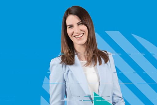 Smiling female executive on blue background