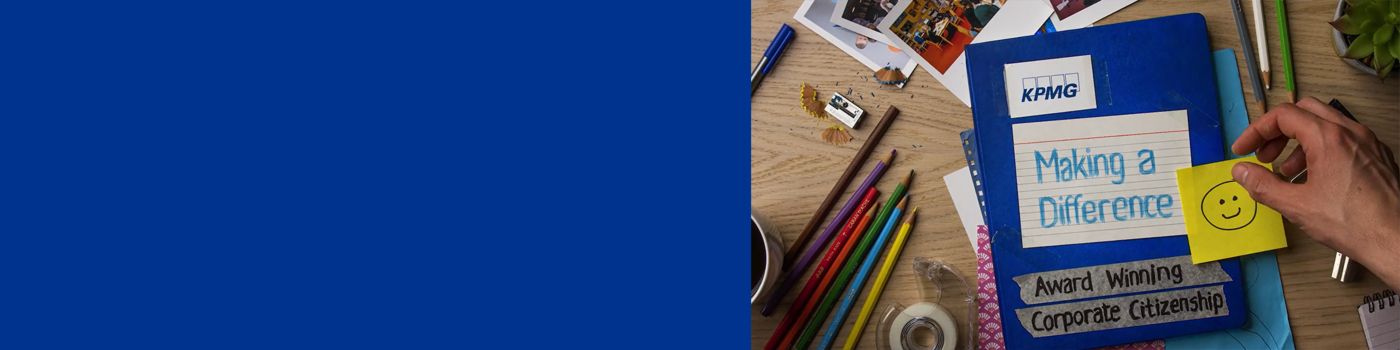 Notebook on craft desk titled KPMG Making a Difference
