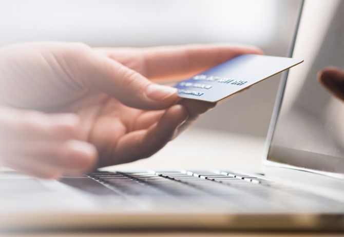 Hands holding credit card and typing - online shopping