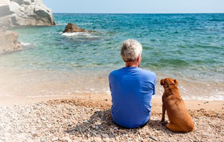 Man at beach with dog