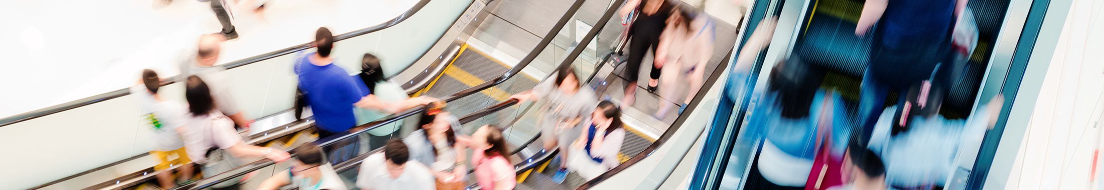 Blurred photo of shoppers on escalators