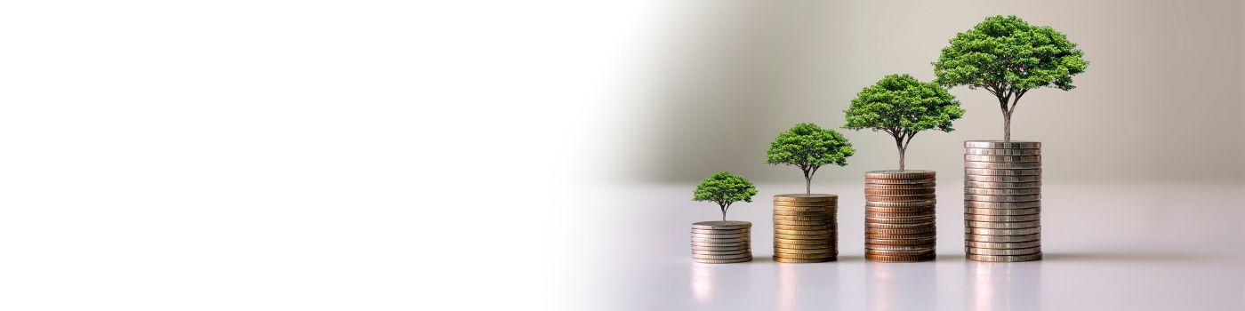 Green trees growing out of stacks of coins
