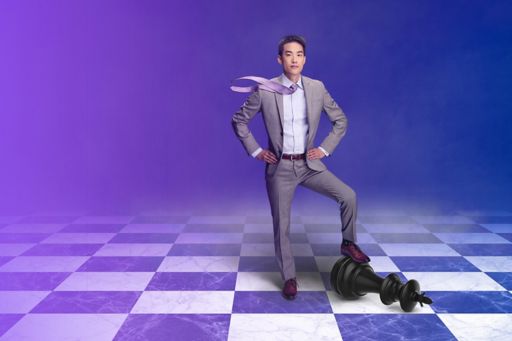 Ivan Wong standing on a chess board