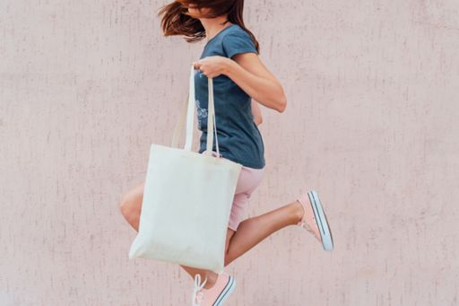 Jumping girl with shopping bag