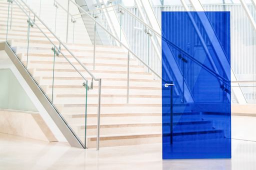 blue glass door in glass corridor