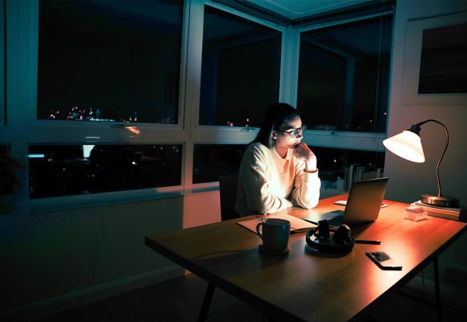 Lady working on laptop at night