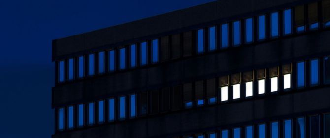 lighted windows in office building at night